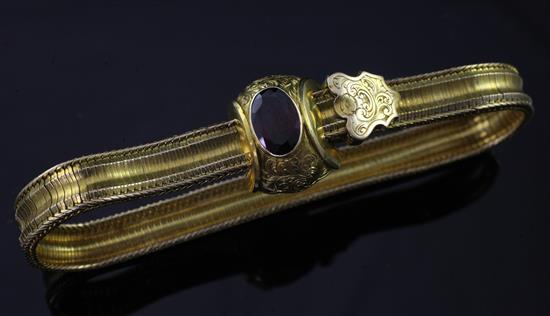 A Victorian gold and garnet snakelink slide action bracelet, gross 18 grams.